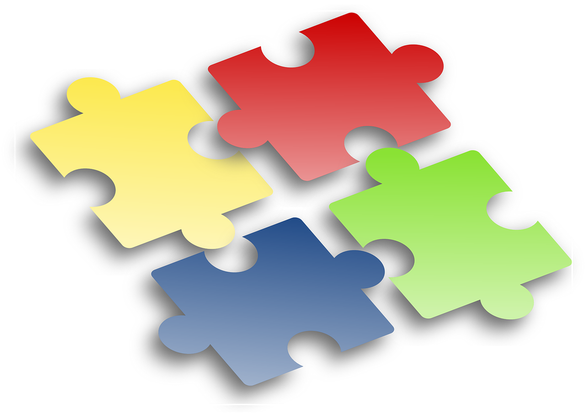 Vier Puzzleteile In den Grundfarben rot, grün, gelb und blau.